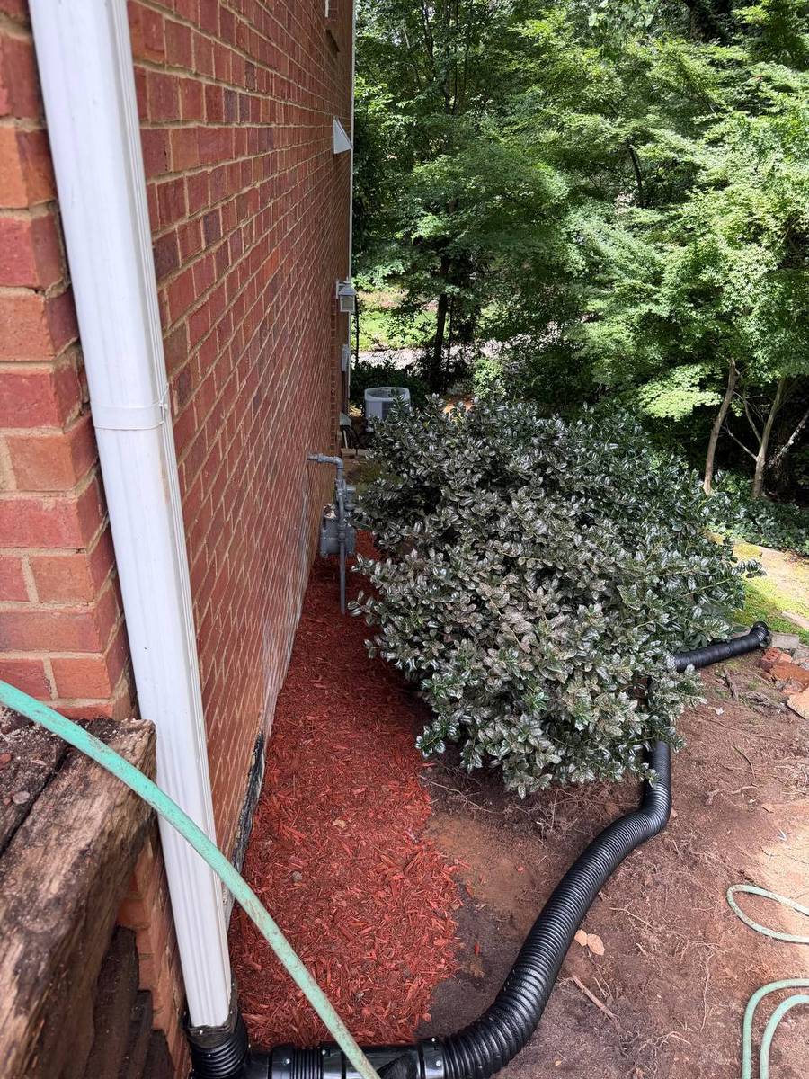 Finished mulch bed and stone edging along the front porch after the job