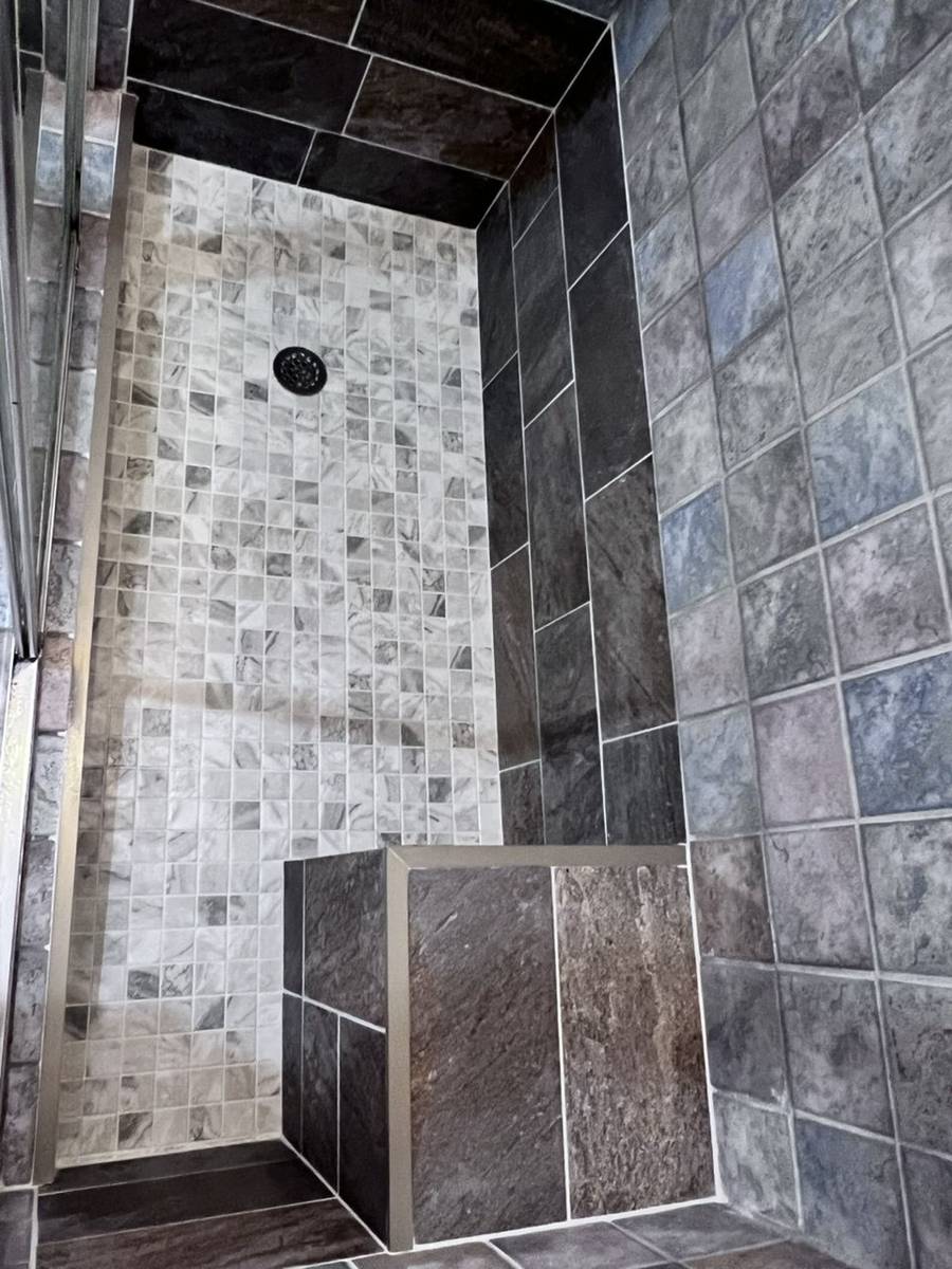 Finished shower floor with new mosaic tile and matching tiled bench seat, water now draining properly