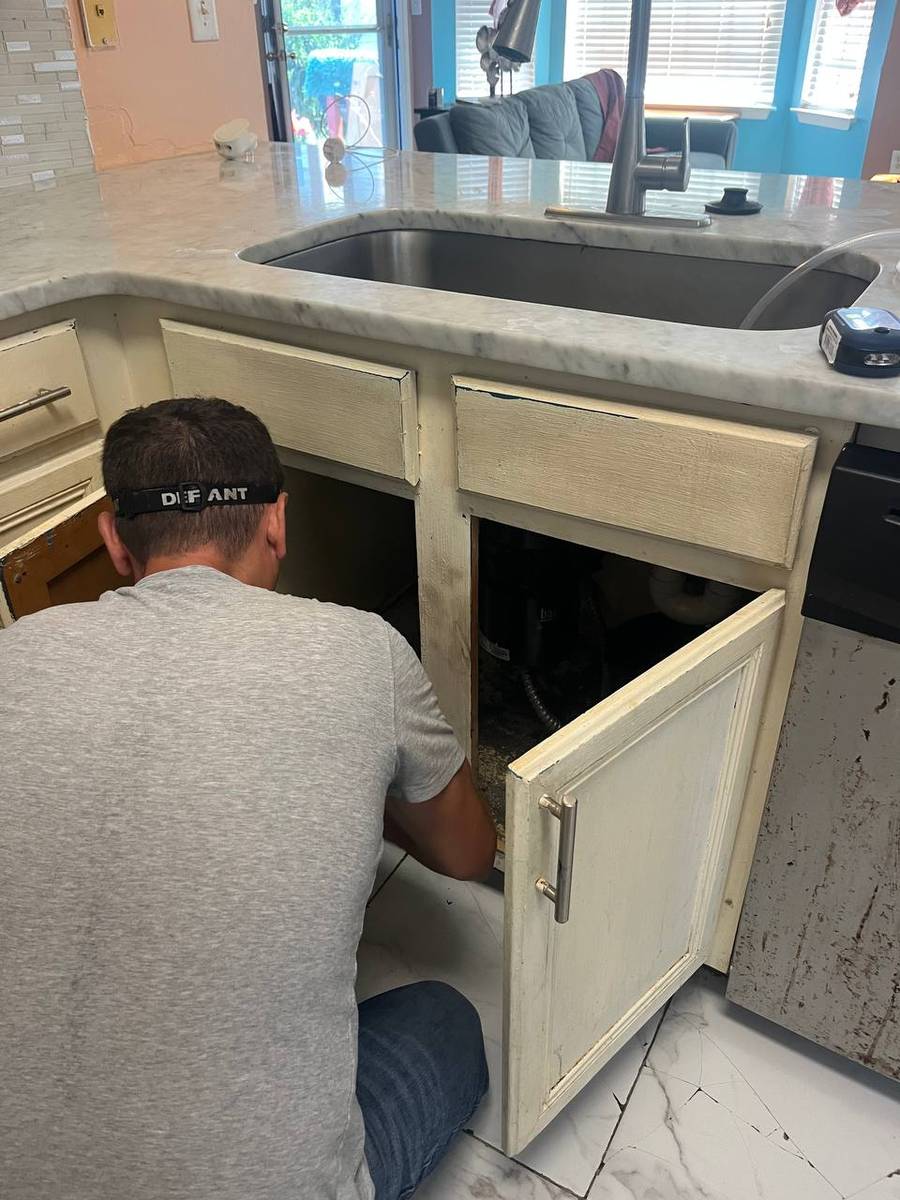 Repairing an incorrectly connected kitchen sink drain leaking under the cabinet